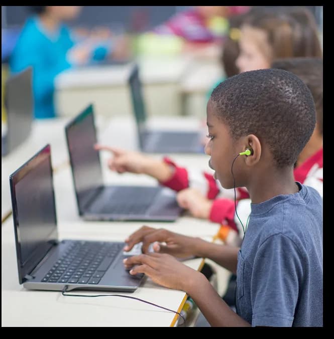 Students learning on laptops in a classroom